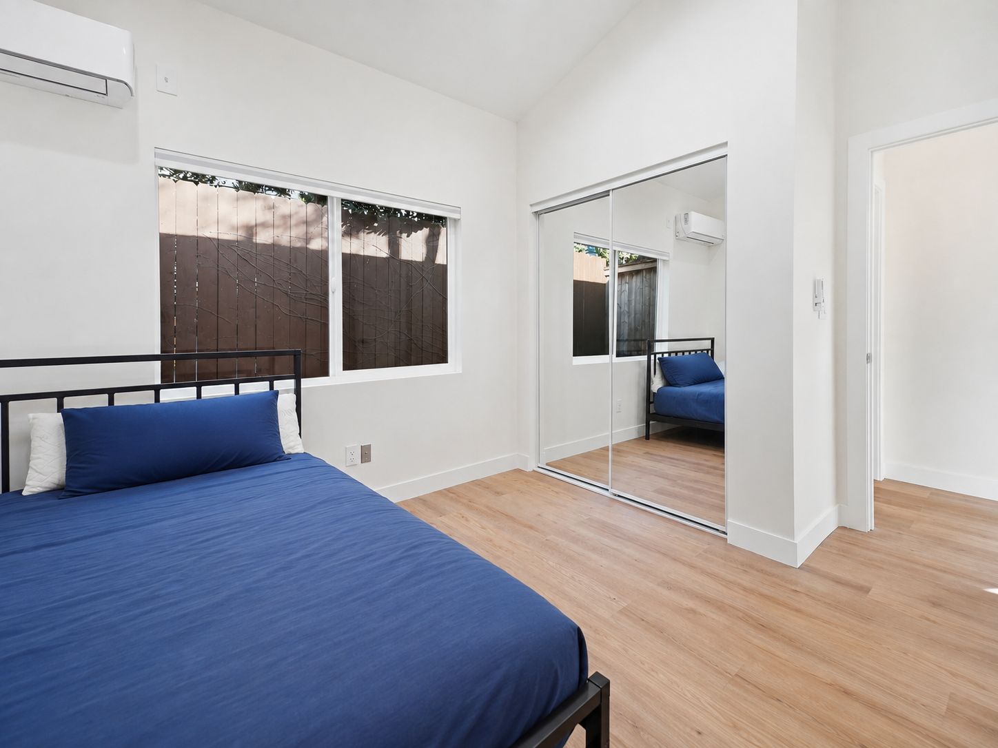 Primary bedroom with mirrored closet doors