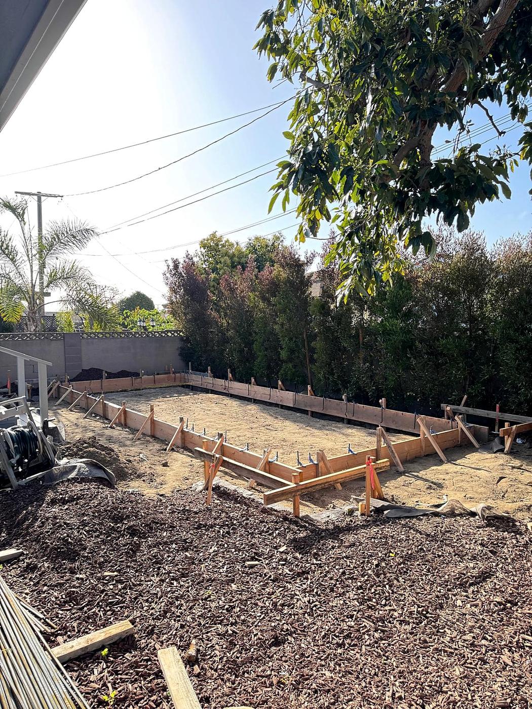 Slab-on-grade foundation and framing, sited at the rear setback
