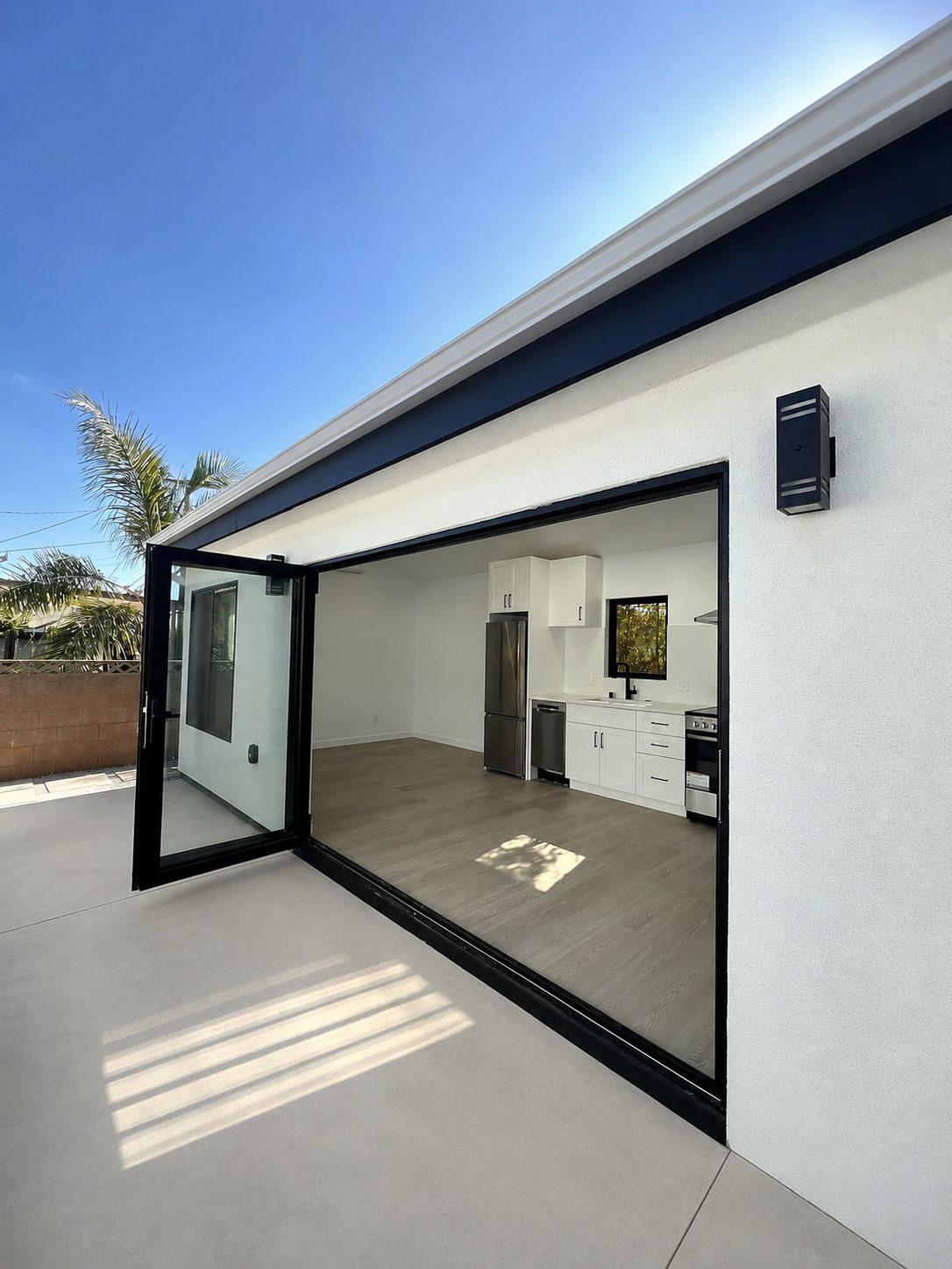 3-panel trifold door opening from patio into the kitchen