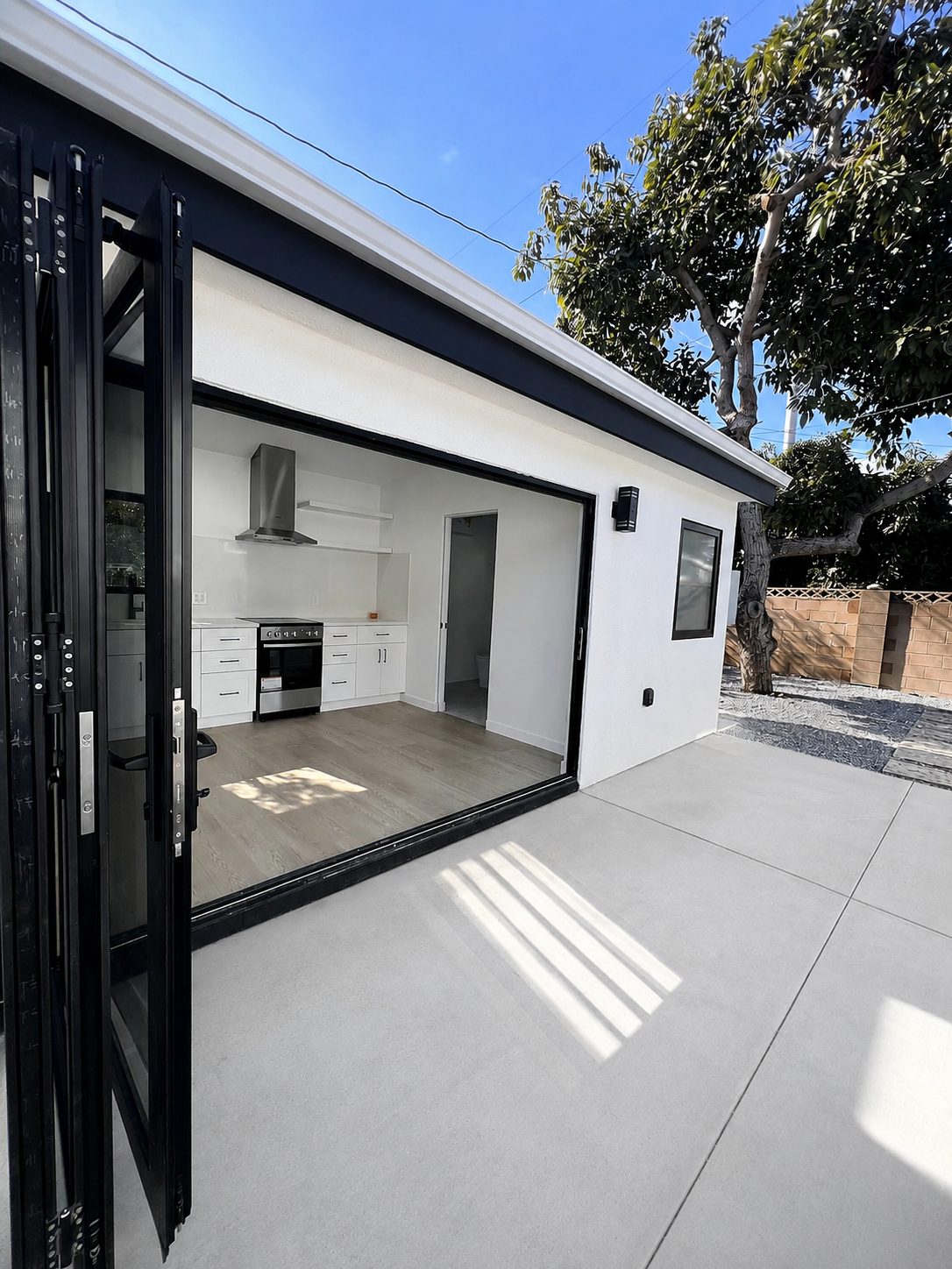 Exterior view of the studio ADU with open trifold door