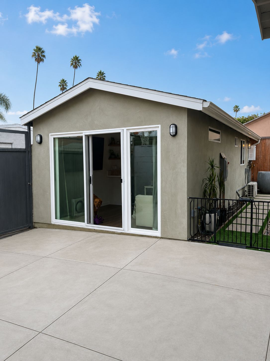 Finished garage conversion exterior with open sliding door