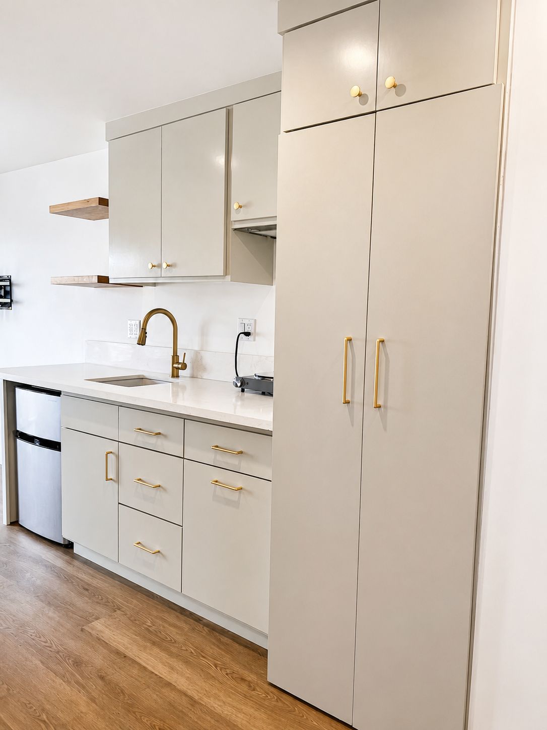 Kitchen pantry cabinet and counter with gold fixtures