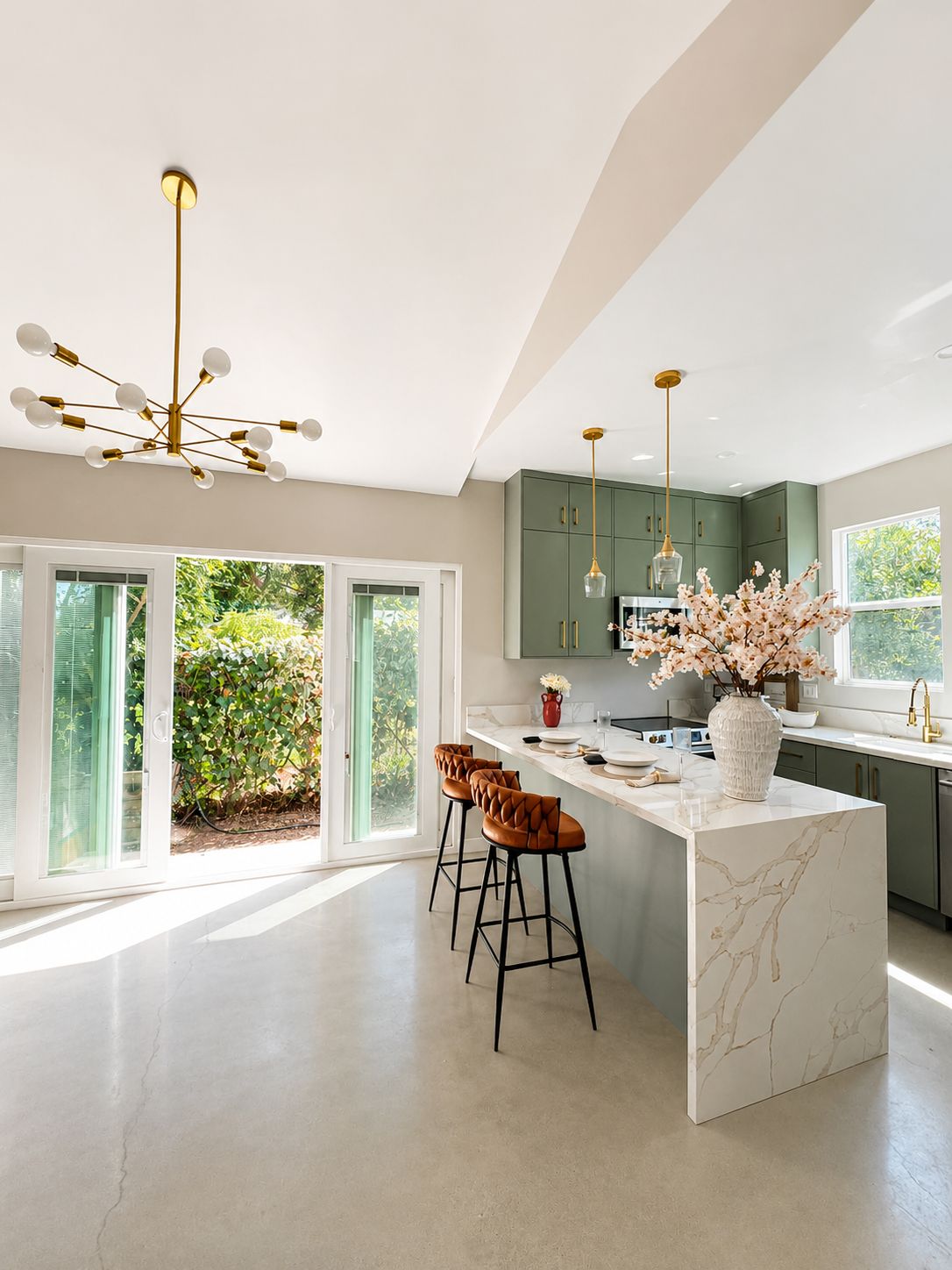 Kitchen with olive green cabinetry and marble waterfall island