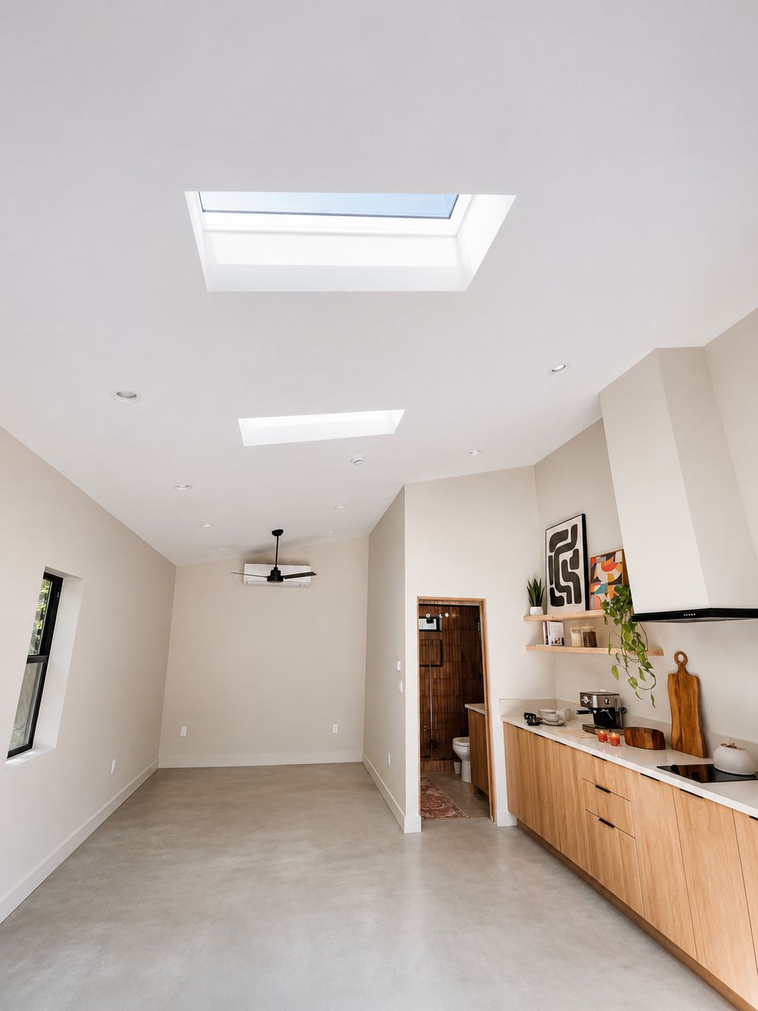 Living space with vaulted ceiling and dual skylights