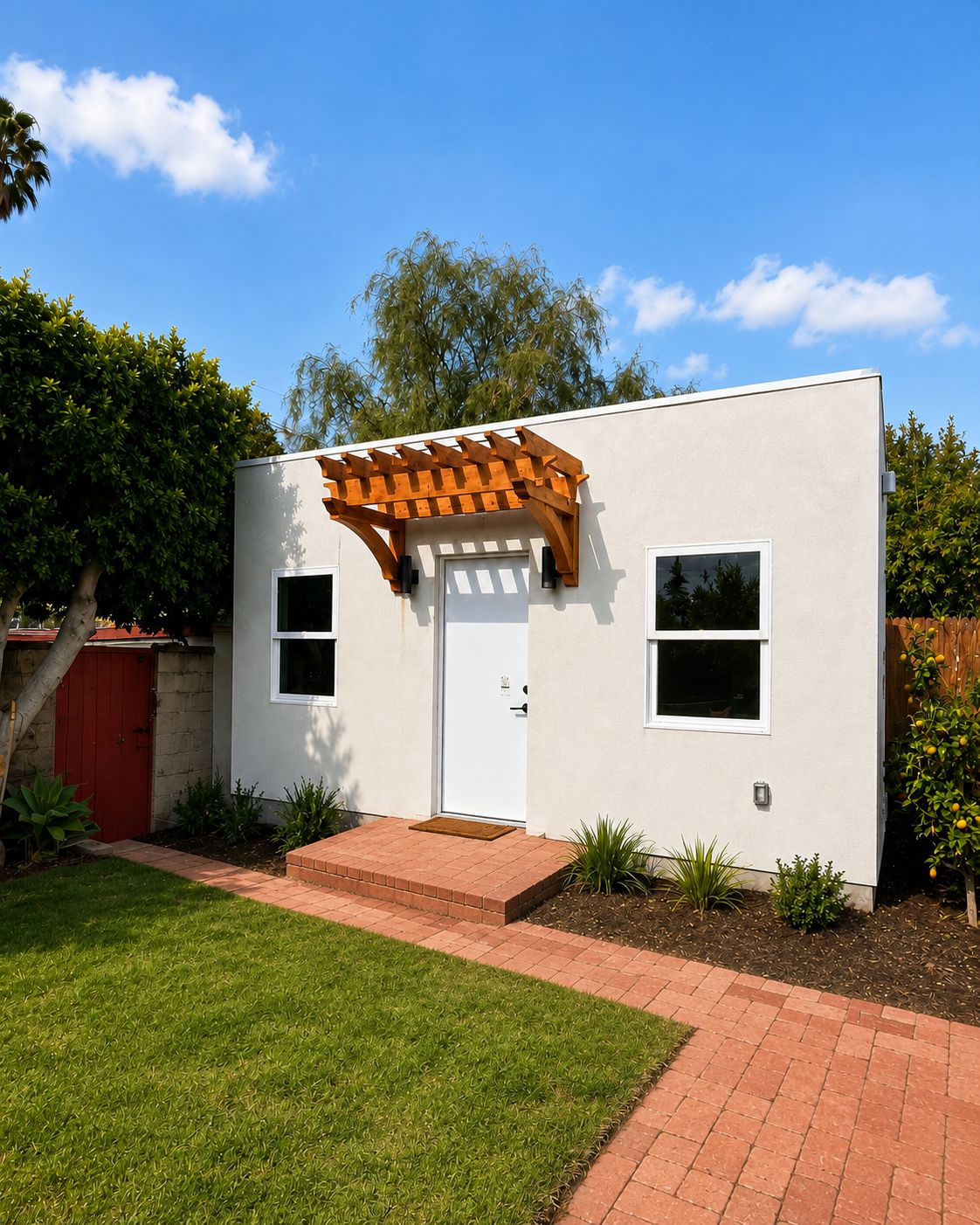 Angled exterior view with landscaping and brick walkway