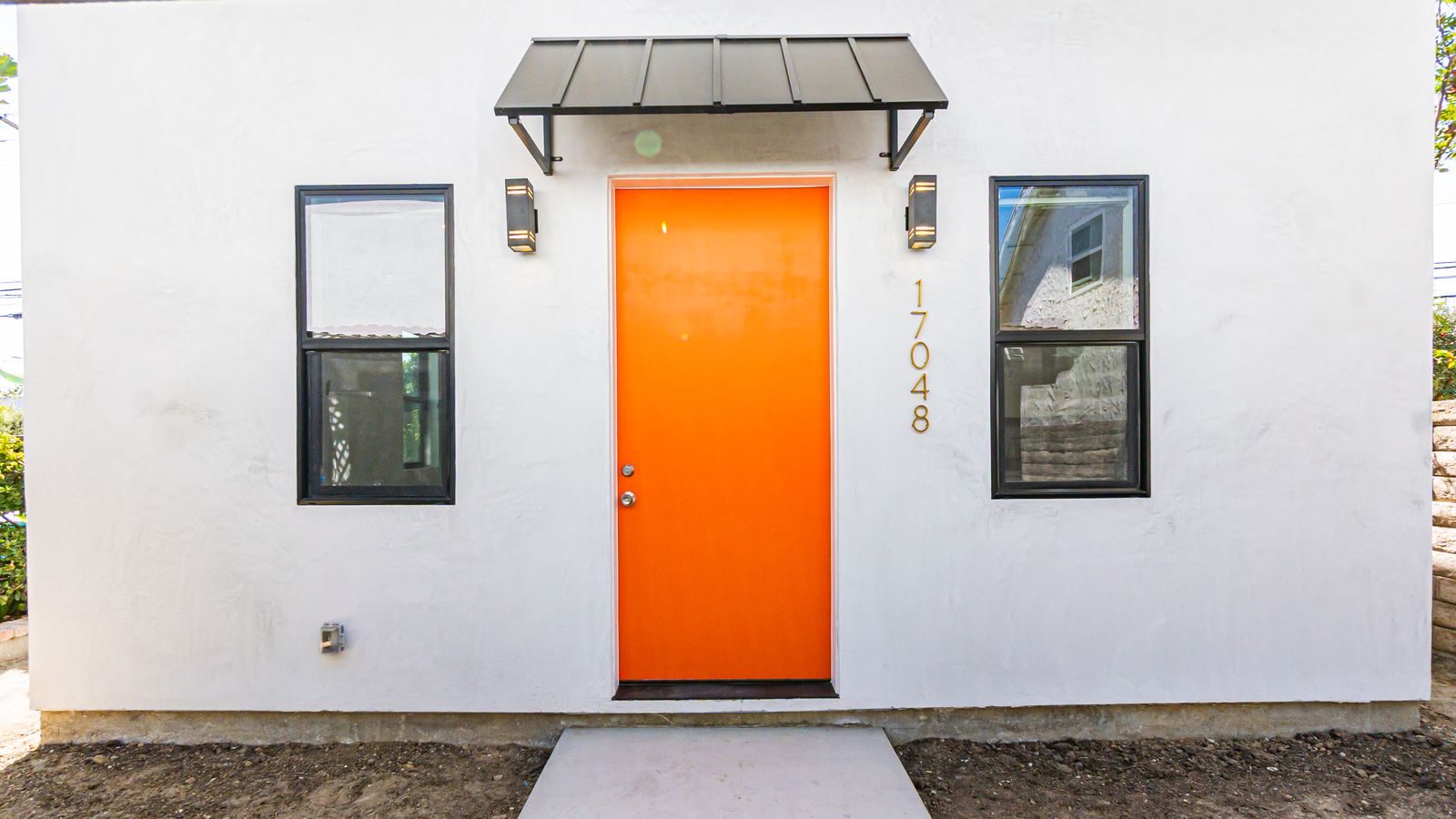 Finished ADU exterior with orange front door