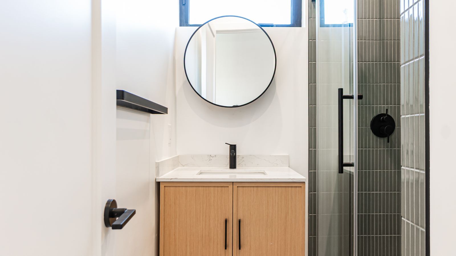 Bathroom vanity close-up with black fixtures