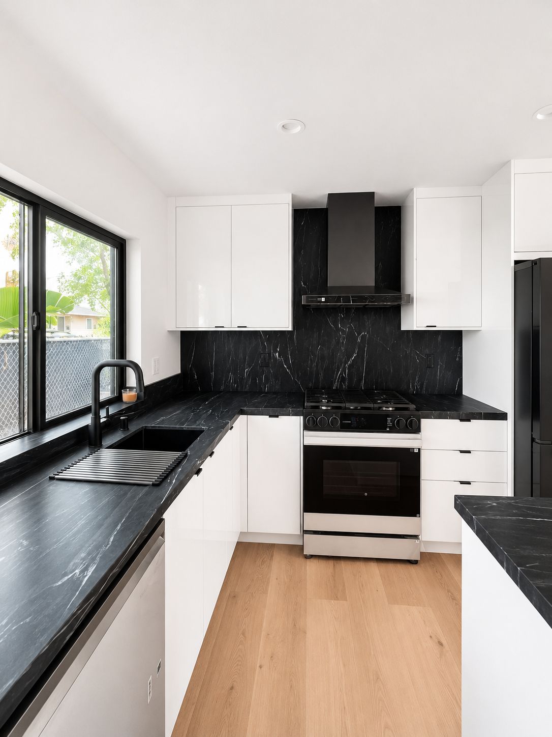Kitchen counter with black marble backsplash and stove