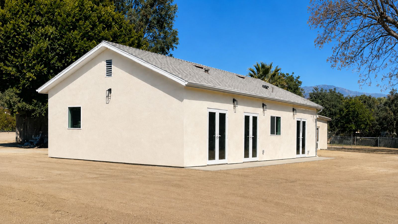 Finished ADU exterior with French doors and stucco siding