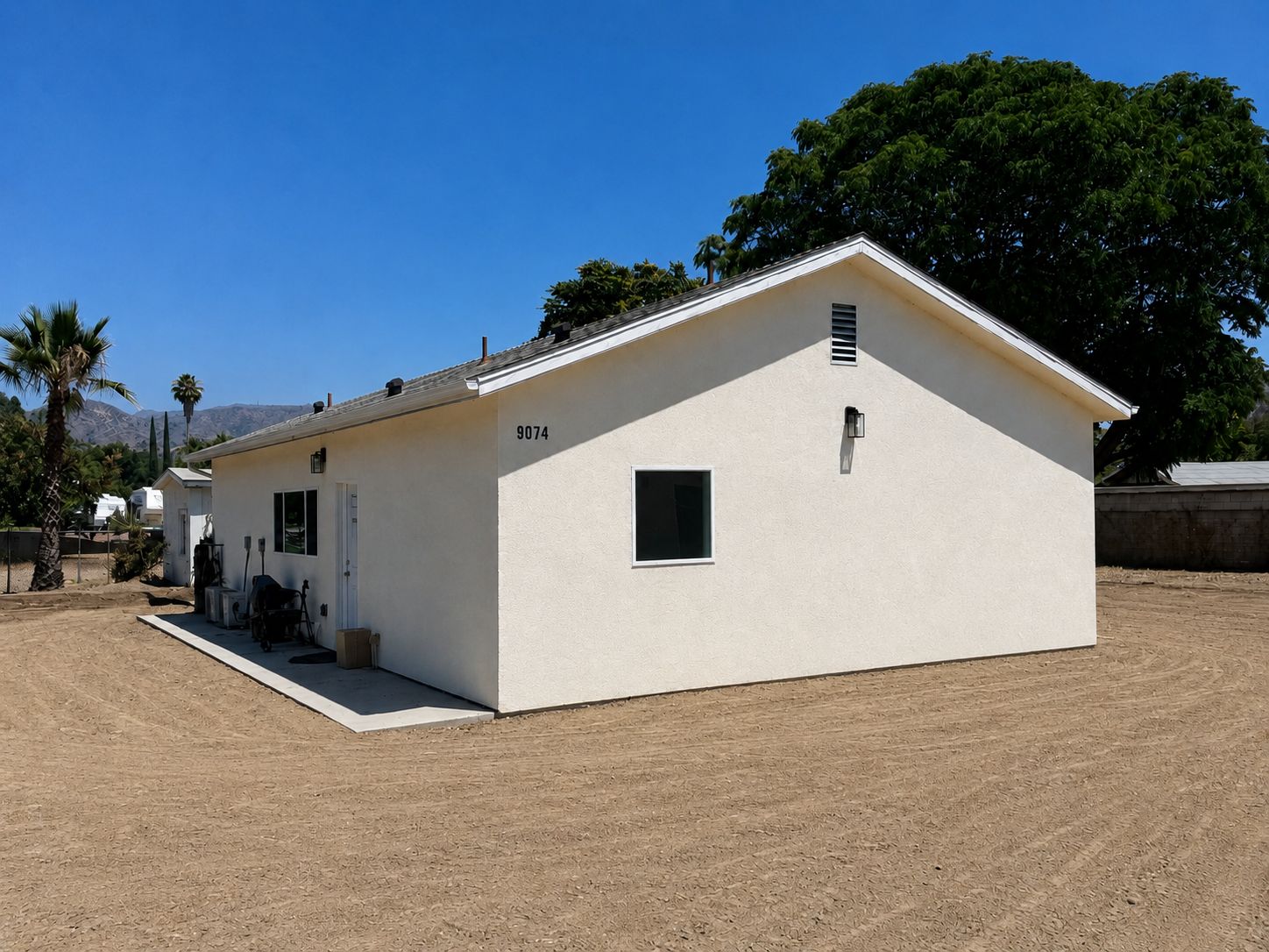 Side exterior view with address numbers and covered entry