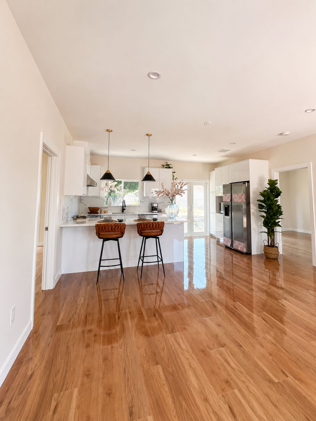 Open kitchen with island seating and stainless refrigerator