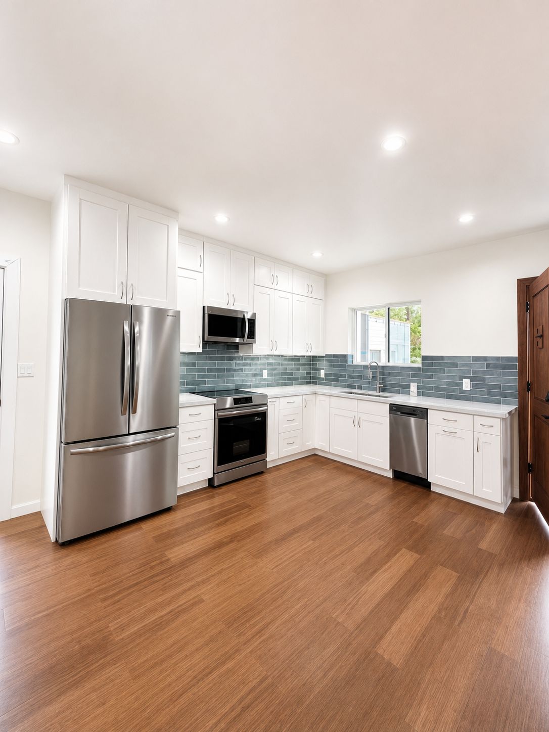Kitchen with french-door refrigerator and white shaker cabinetry