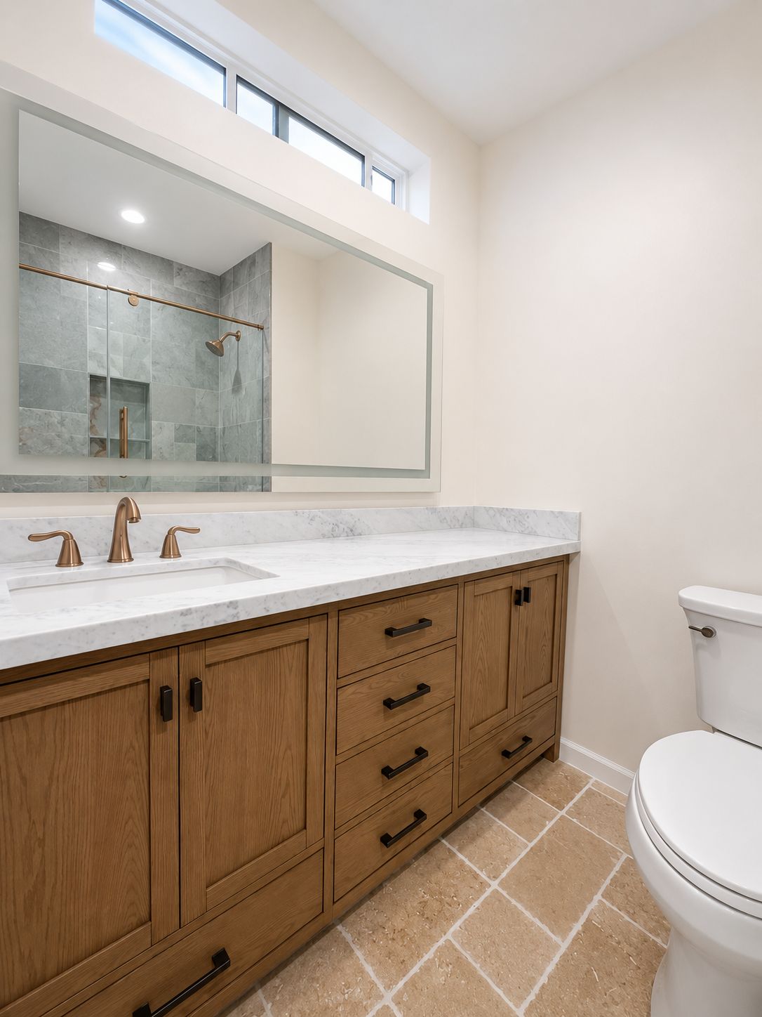 Bathroom vanity with marble counter and brass fixtures