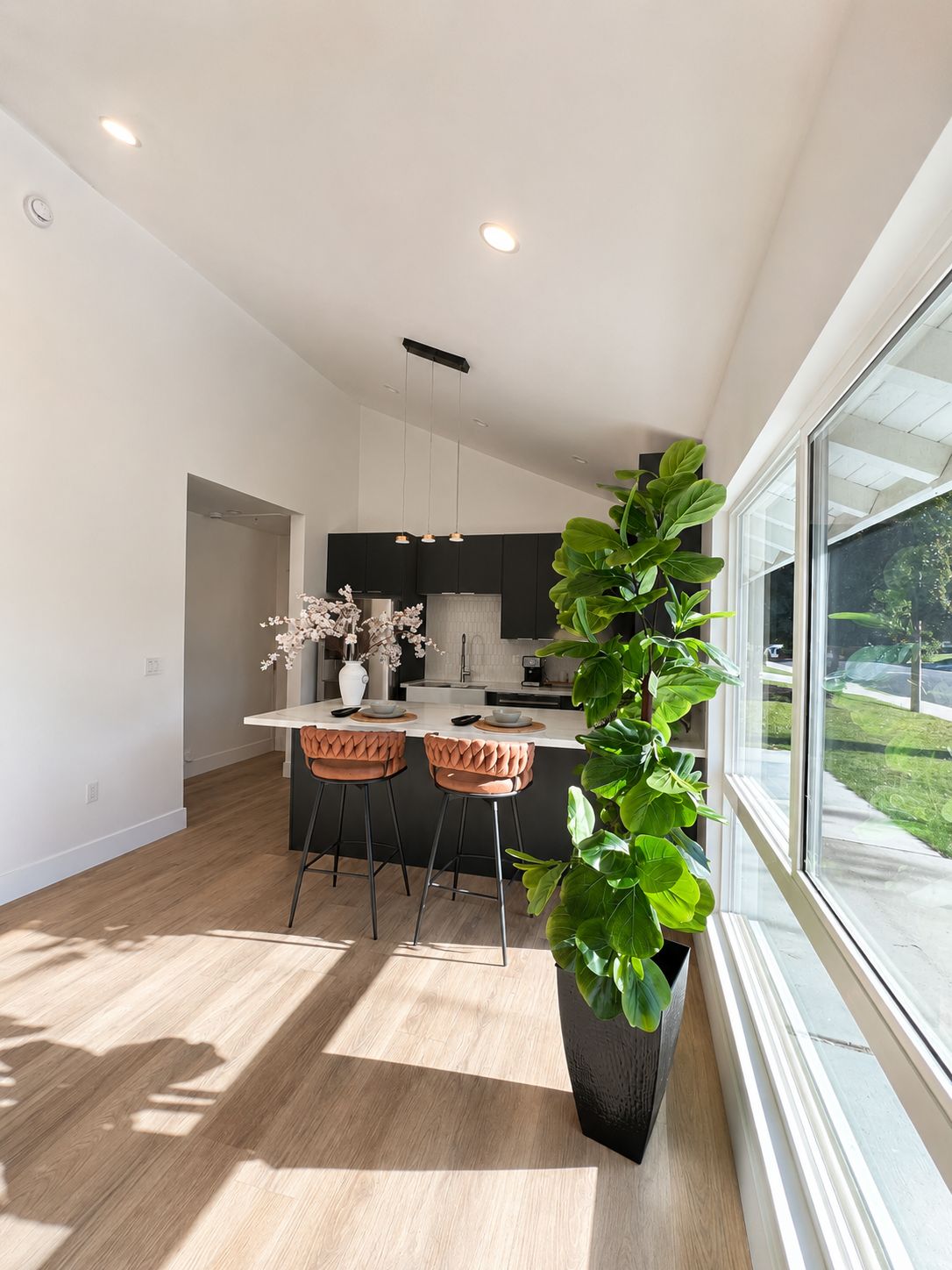 Living area with view toward the kitchen and large window