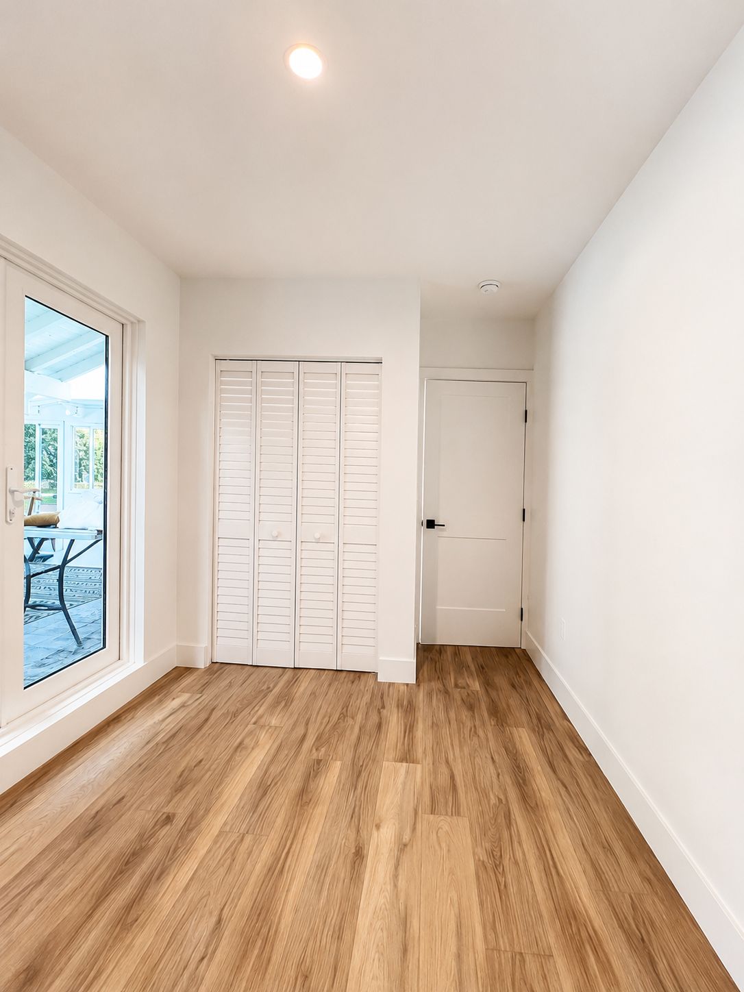 Finished bedroom with louvered closet doors